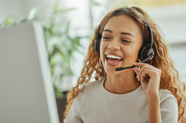 Customer service, happy and communication of woman at call center pc talking with joyful smile.