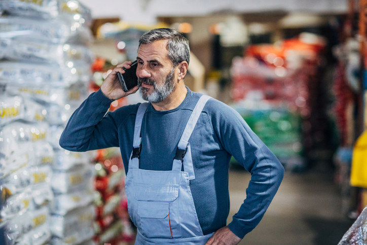 Warehouse owner on the phone looking upset